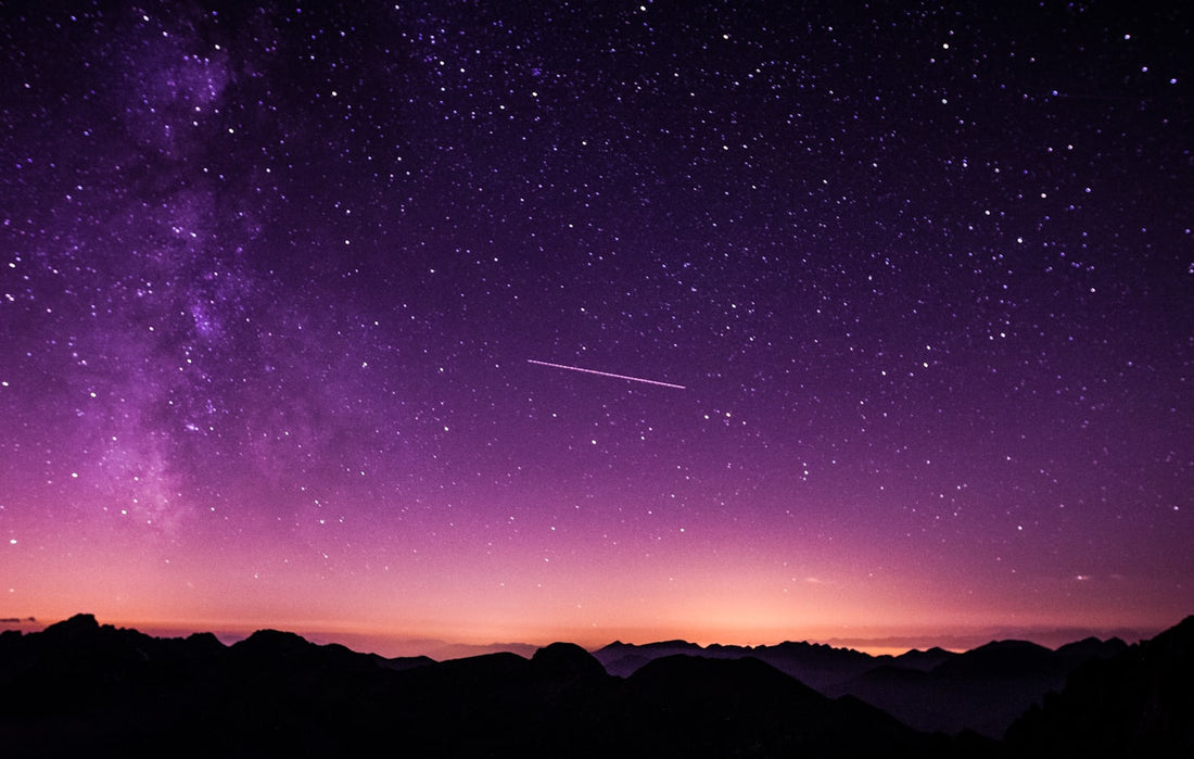 Serene starry night sky over misty mountain lake peaceful and calming