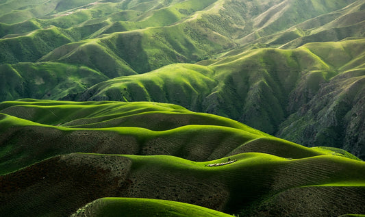 Hiker with backpack in rural mountain landscape