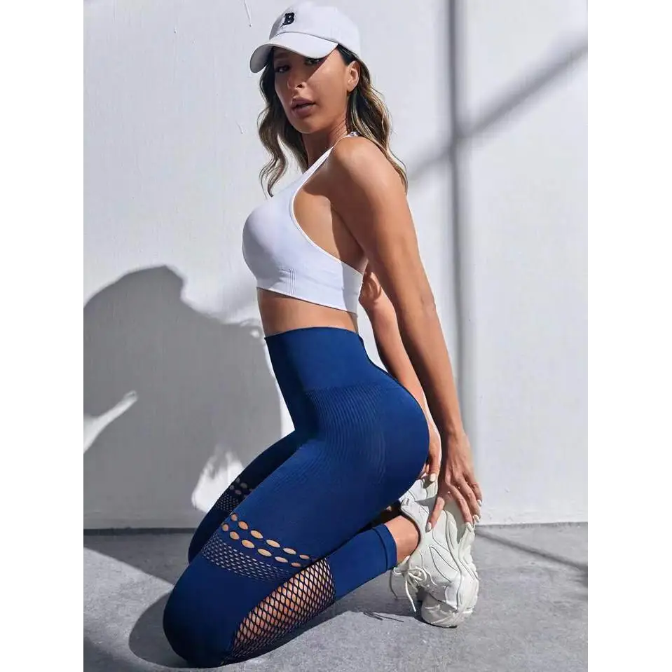 Pantalones de yoga sin costura ahuecados con paneles de malla